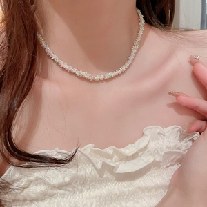Gros plan d'un collier de perles étoiles colorées avec perles roses et vertes sur un mannequin