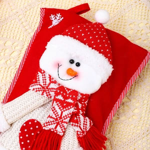 Close-up of knit Christmas stocking featuring a 3D snowman with textured felt details