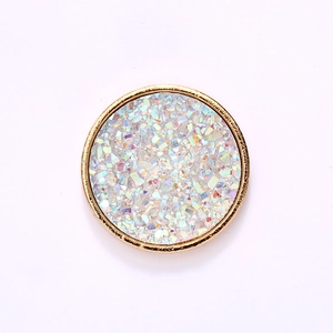 Golden round DIY accessory with colorful crushed stones and polished metallic finish