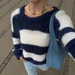 Women's blue and white striped knit sweater in a loose casual style for autumn