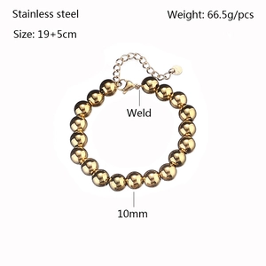 Detail shot of 10mm golden stainless steel beaded bracelet with welding process info