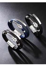 Close-up of leather braided bracelets with guitar pendants in brown, blue, and black colors