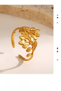 Detailed macro shot of adjustable gold leaf ring with matte finish on rock prop