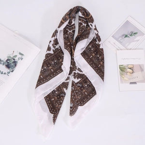 Close-up of vintage paisley pattern on a white linen cotton square scarf with geometric border