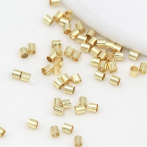 Macro shot of 18K gold plated metal crimp beads for DIY jewelry bracelet making
