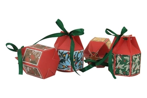 Detail of four red Christmas candy gift boxes with festive patterns and green ribbons