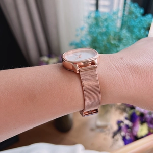 Elegant rose gold square dial women's quartz watch with metallic mesh strap on wrist