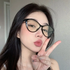 Close-up of black cat-eye glasses frame with blue light blocking lenses on a model