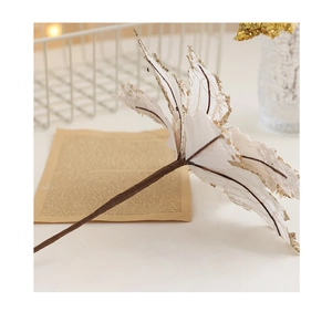 Macro shot of white Christmas flower petals with gold glitter edges and stem details