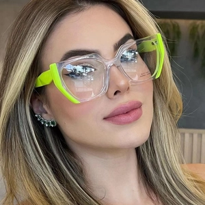 Close-up of cat-eye frames in transparent and neon green acetate with logo detail