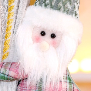 Detail of Christmas Santa curtain buckle with pink plaid and green sequin hat decoration