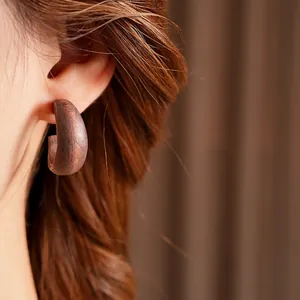 Retro C-shape earrings made of dark brown solid wood with a natural wood grain texture