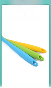 Detail of integrated silicone spatula handles in three colors with hanging holes
