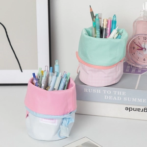 Vertical canvas pencil case showing the standing telescopic function and stationery storage