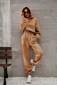 Detailed side view of camel cotton hooded tracksuit featuring ribbed cuffs and side pockets