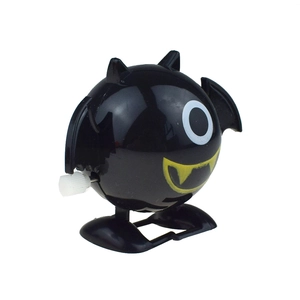 Detail of a wind-up black bat toy with big eyes and yellow fangs for Halloween gifts