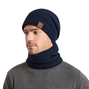 Navy blue winter knitted beanie and neck warmer set with leather patch on white background
