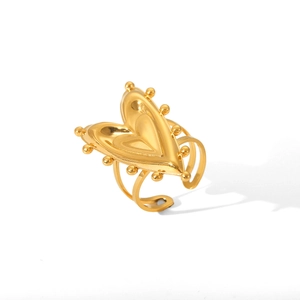 Detailed view of a golden stainless steel heart ring with polished bead texture