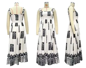 Detail of smocked bodice and bohemian print on a black and white long beach dress