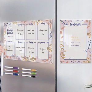 Detail of magnetic acrylic weekly planner and to-do list with 6 colorful markers on fridge