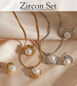 Macro detail of gold and silver jewelry sets with pearls on champagne satin background