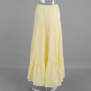 Close-up of yellow tiered maxi skirt featuring elastic waistband and crinkle texture