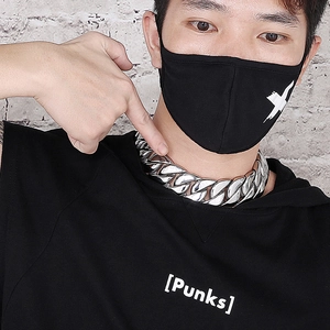Classic silver cuban link chain for men shown on a model with an industrial backdrop