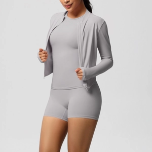 Detail of grey sports set featuring zip jacket with thumbholes and high waist shorts