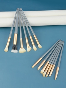 Macro shot of 13 professional eye makeup brushes with soft bristles and gold ferrules