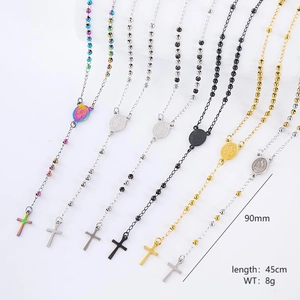 Detail of colorful rosary necklaces with crucifix and St. Benedict medal pendants
