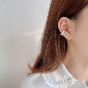 Detail of silver wavy layered ear cuff shown on model for non-pierced ears