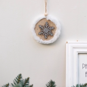 Wooden snowflake Christmas ornament with silver glitter and white faux fur trim
