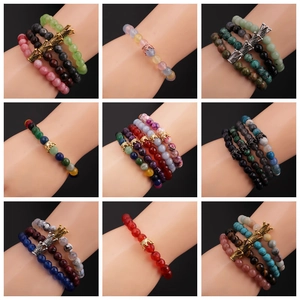 Detail of 8mm faceted stone bead bracelets with crown charms on a display model