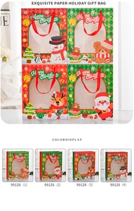 Detail of Christmas paper gift bags with transparent window and red ribbon handles