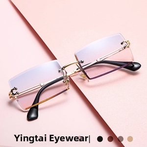Detail view of rimless square sunglasses with gradient pink lenses and gold metal frames