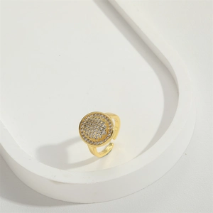 Minimalist gold open ring featuring a sparkling turquoise circle with pave crystals