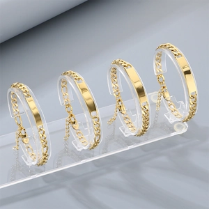 Gold-colored Cuban link bracelet with engravable curved bar on acrylic stand