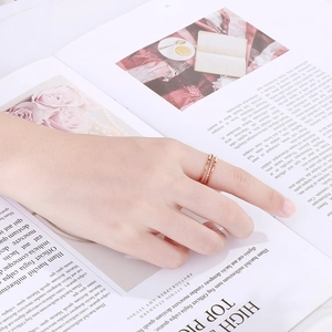 Close-up of three-layer rose gold titanium ring with pavé setting on lifestyle background