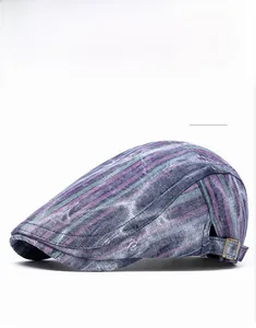 Close-up of blue striped beret cap featuring vintage bronze side adjustment buckles