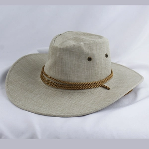 Close-up of woven light brown cowboy hat with dark braided band and metal air vents