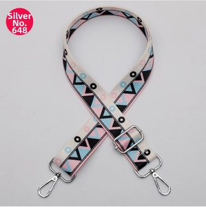 Detail of 38mm wide canvas strap with pink and blue geometric patterns and silver hardware