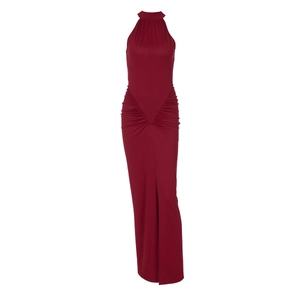 Detail of red halter maxi dress featuring waist pleats and a high side leg slit