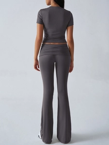 Rear view of dark grey two-piece set featuring short sleeve top and flare yoga pants