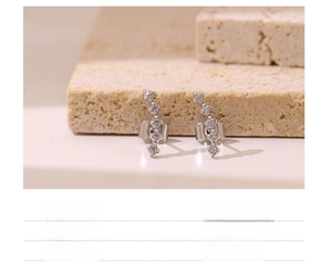 Macro shot of curved titanium steel stud earrings with shimmering small cubic zirconia stones