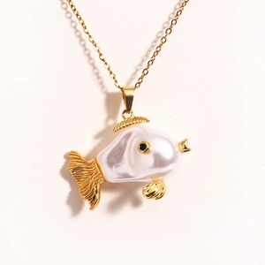 Close-up of cute gold fish necklace with white pearl body and black bead eye detail