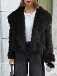 Detail shot of black faux fur cropped jacket texture and plush winter coat material