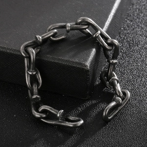 Macro shot of industrial nail-shaped links on a vintage stainless steel bracelet for men