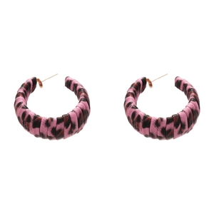 Pink and black leopard print C-shape leather hoop earrings with gold pins on white background