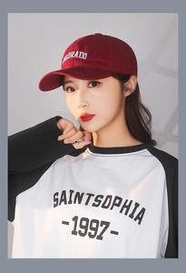 Close-up of burgundy cotton baseball cap with Colorado embroidery and raglan tee