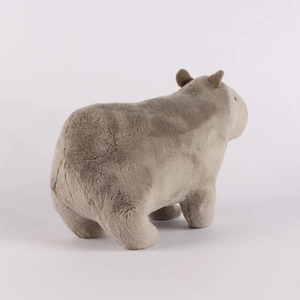 Side view of soft taupe capybara plush toy showing realistic furry texture and details